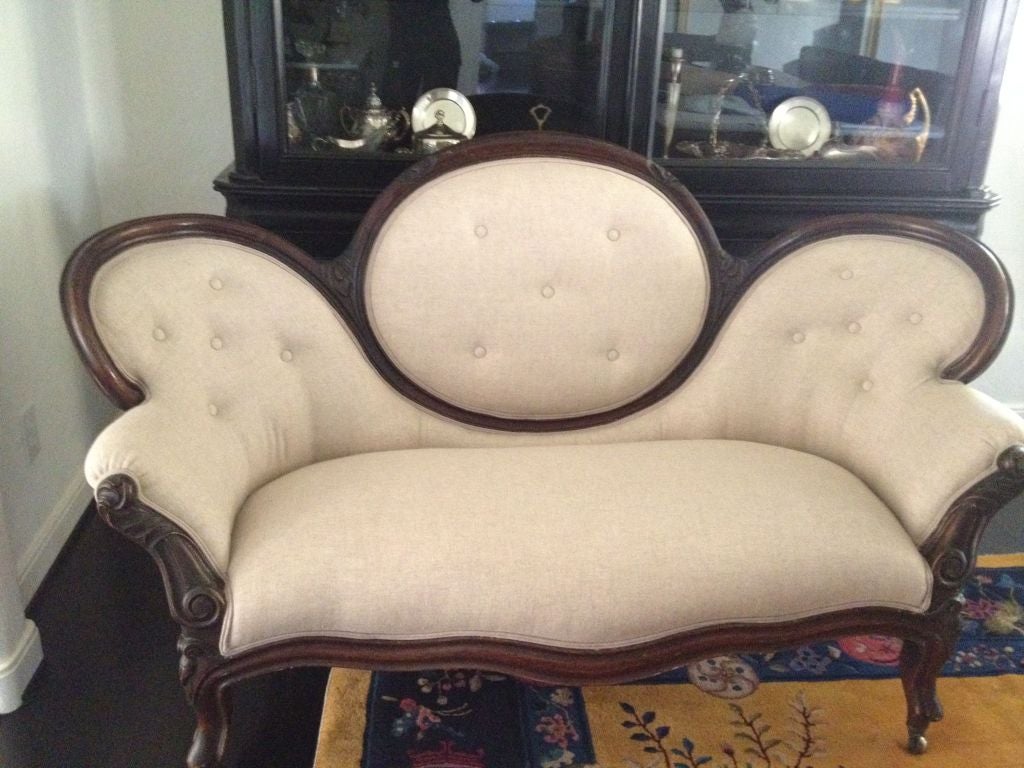 This wonderful Victorian balloon back bergere loveseat sits atop short cabriole legs. Beautiful carved walnut frame complete with rose bud details. This loveseat is both comfortable and beautiful.
It has been upholstered in linen, ready for your