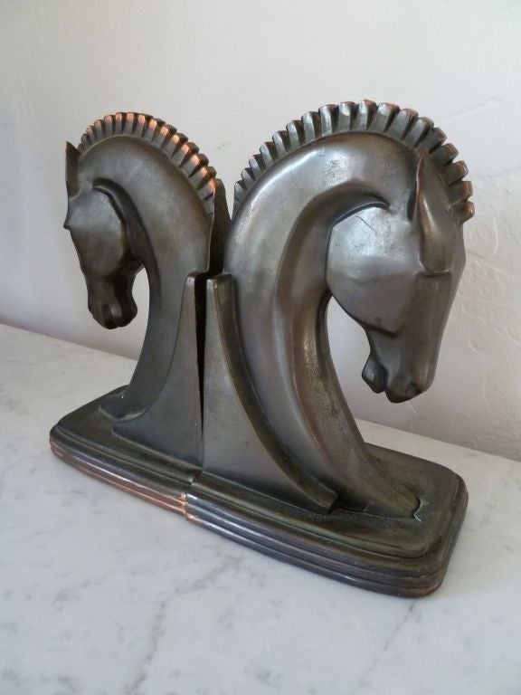 Pair of elegant horse head bookends in cast bronze with a gorgeous natural patina.  Heavy to the touch and great looking from all angles. A handsome addition to any library or desk.