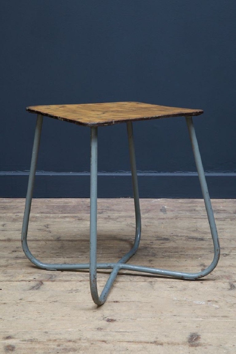 A large run of simple low stools, recovered from a cold war era eastern block army base. 

Painted tubular base with ply seat, marks, scratches to all, incredibly strong and durable, would work as small bedside or sofa tables. 

H: 45cm x W: