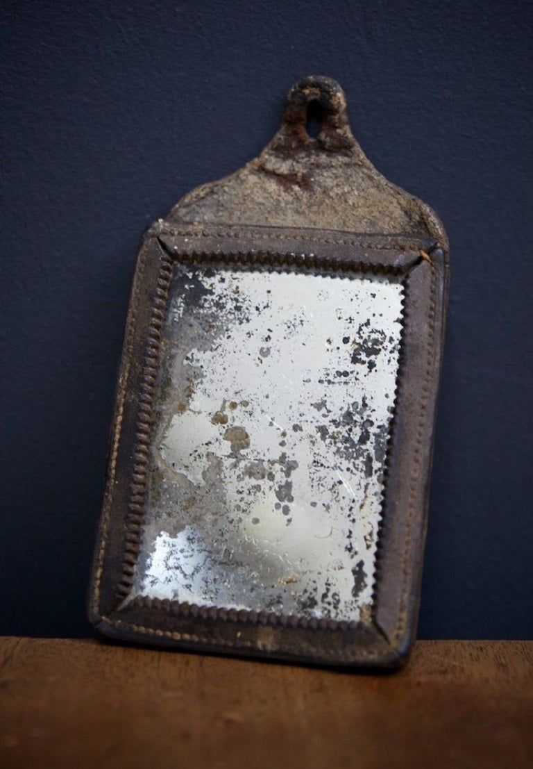 A evocative hide encased 18th century travelling mirror. 

Found condition, untouched plate and sticking . 

H:17 W:9.5 D1.5 CM