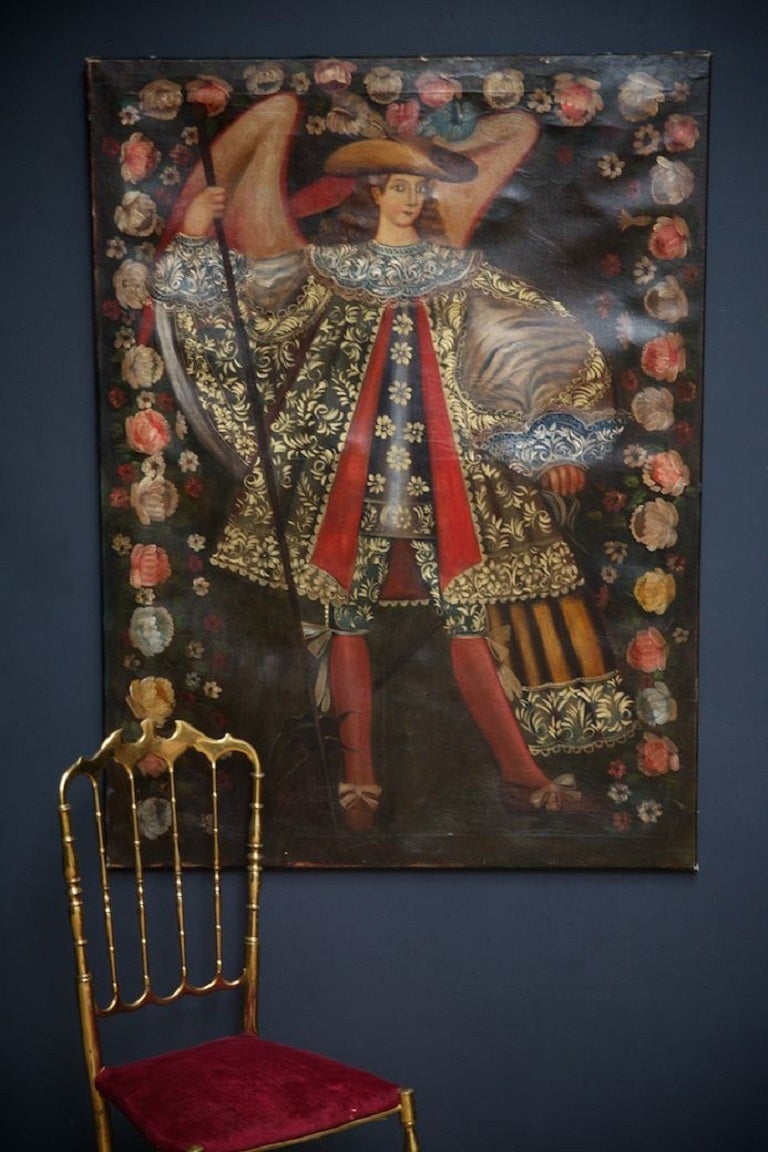 Cuzco school oil on canvas of a winged Angel holding a staff. 

The Cuzco school is a Roman Catholic artistic tradition based in Cusco, Peru. 

The clothing of the figure represents the European influence the Spanish brought to the Incas during