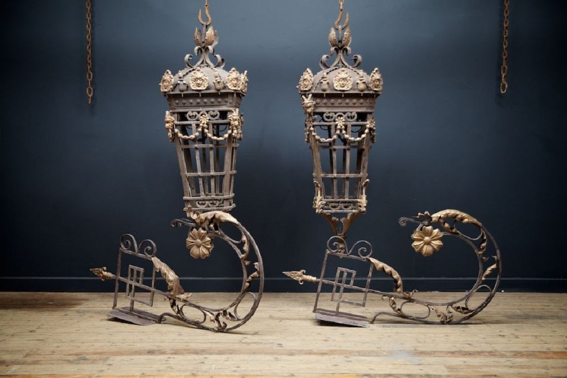 Large wrought iron lanterns with wall brackets. 

Simple construction, old worn painted surface. 

Late 20 th century. 

Seven available, various sizes. 

Price is for the pair 

H:156 W:63 D:63 CM 

Brackets 

H:120 W:21 D:66 CM