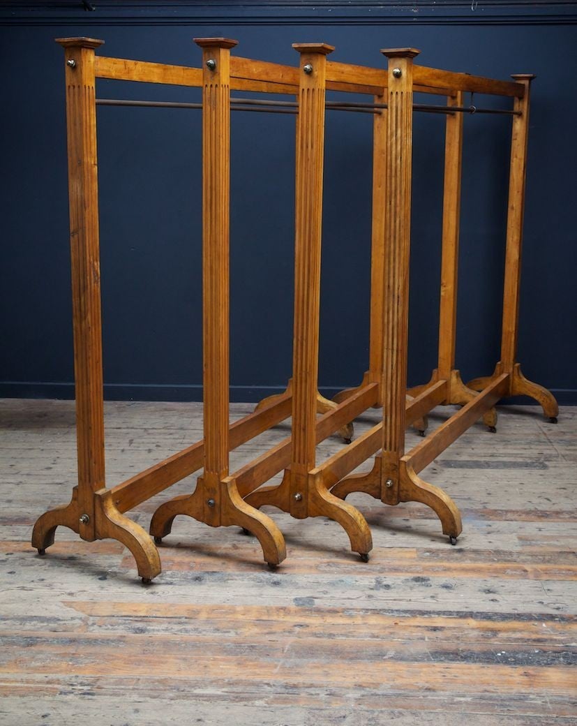 Four early 19th century satinwood and steel cloak room coat rails. 

The square supports reeded to three sides, supporting a plain stretcher with steel rail below, down swept leg with steel castors. 

Scottish Circa 1830. 

Four available,