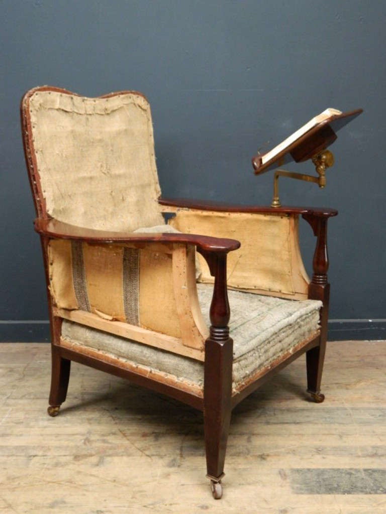 Edwardian Library or reading chair, mahogany frame ready for re-upholstrey.

Book holder on bronze adjustable arm, original brass and ceramic castors.

