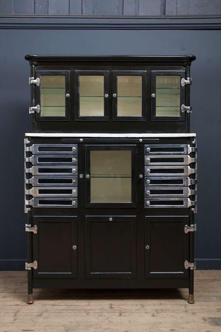 A incredible dentists cabinet.
Black painted timber frame raised on copper clad feet chromed swing out trays.
All original bevelled glass to the doors and shelves, factory fitted locks and keys all working, marble shelf to the stepped front has an