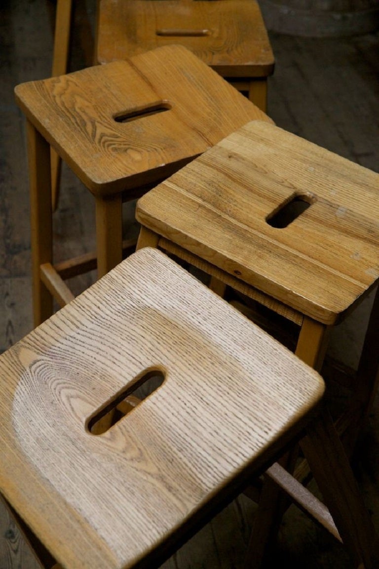 A large run of school lab stools with hand holes. 

Maple frames with oak seats. 

Excellent condition, 

English 1960s. 

Eighty (80) available, price is per stool. 

W:61 W:33 D:33 CM
