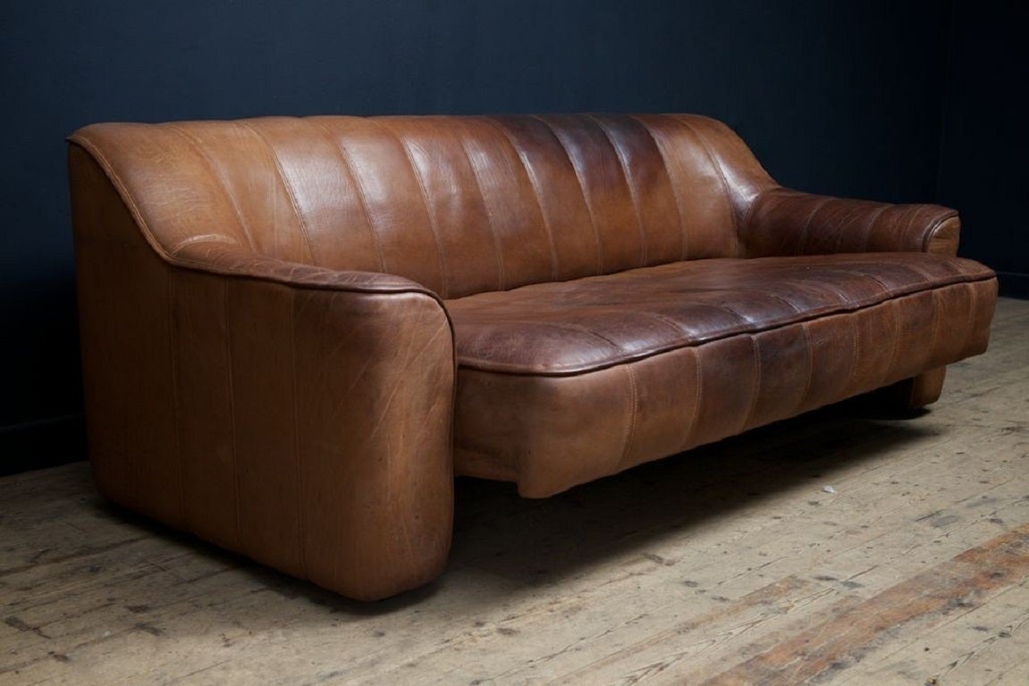 A tan leather sofa by De-Sede of Switzerland . 

Seat slides forward to create a day bed. 

1970. 

H:68 W:186 D: 80 CM