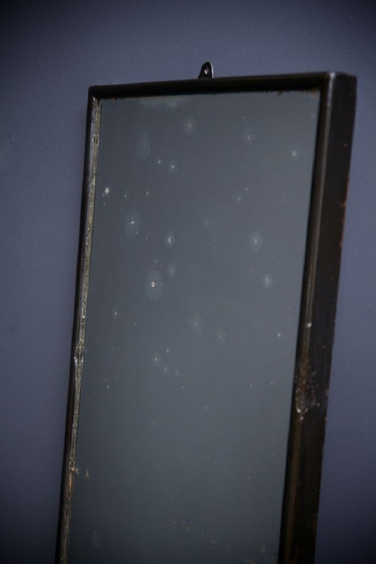 A tall thin Taylor’s mirror. 

Original distressed mirror plate and back boards, ebonised frame with overpainting. 

English 1920s. 

H:155 W:49 D:4 CM