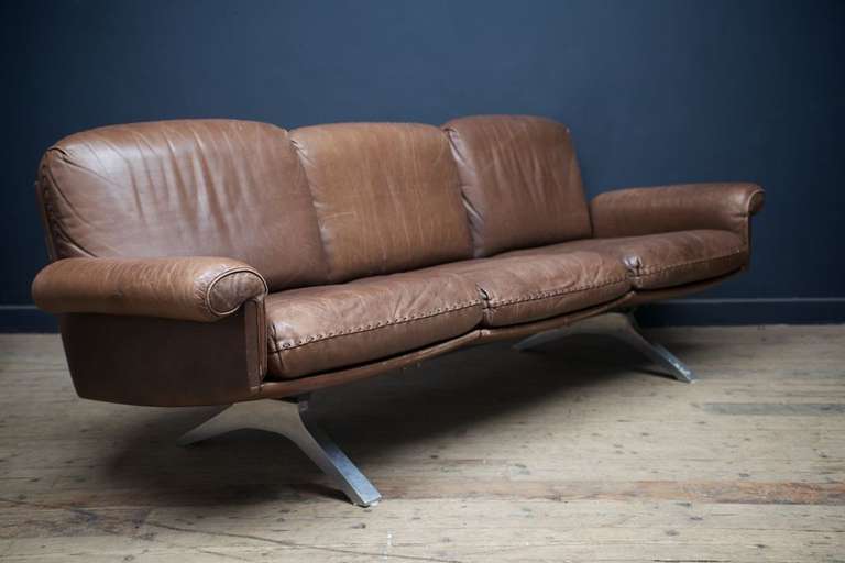 A fabulous quality brown leather sofa on cast alloy bases.
Manufactured by 