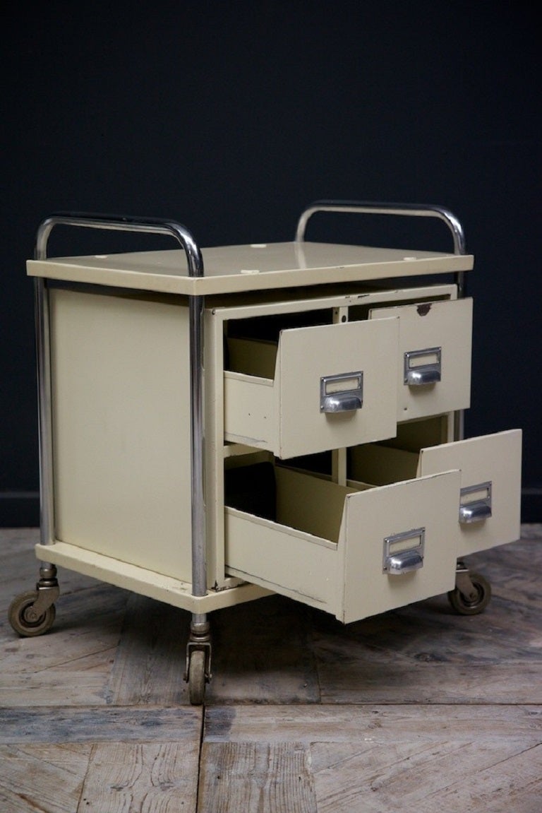 A painted steel four drawer medical trolley. 

Chrome frame and drawer pulls, rubberised castors. 

English 1950s. 

H:69 W:589 D:41 cm.