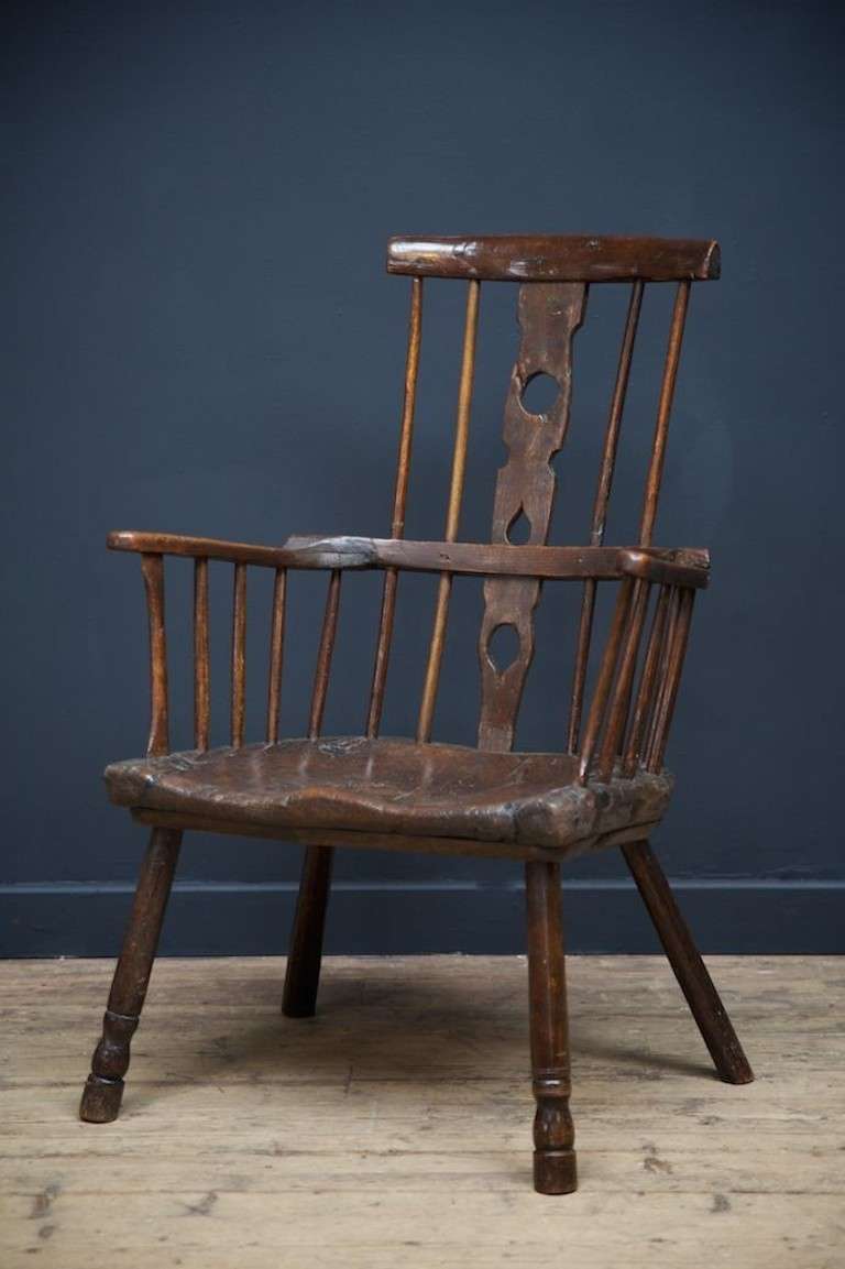 Primitive comb back Windsor armchair.
Ash and elm construction, balasture turned front legs, (rhs replaced)! Back splat taking design hints from Welsh love spoons of the same era.
Single section thick plank seat is untouched and has incredible