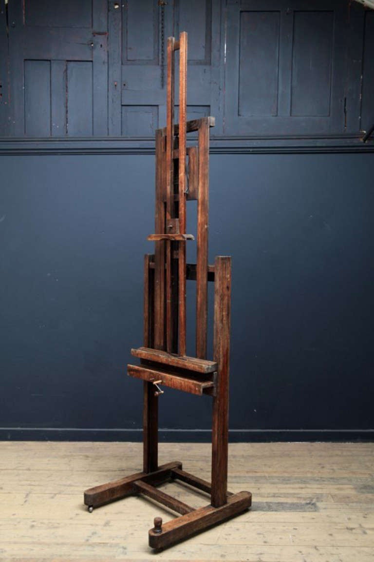 An artists studio easel. 

Oak frame on steel castors, wooden and steel wom gears. 

As found, fully functioning condition, unusual mechanism to tilt the canvas forward. 

English, circa 1880.