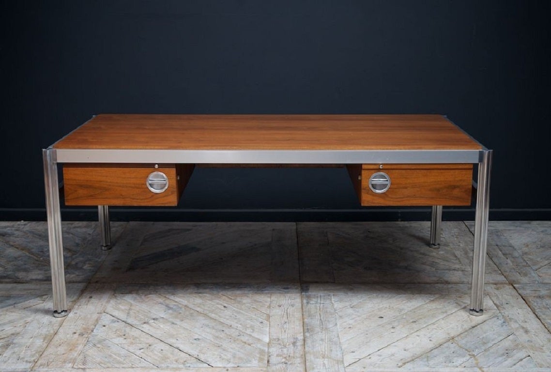 A Jens Rinsom executive desk. 

Walnut and brushed alloy supported on cast and polished alloy cluster column legs in a quatrefoil form. 

American 1960s. 

Possibly a exhibition piece or a bespoke manufacture. 

Excellent condition. 

H:73