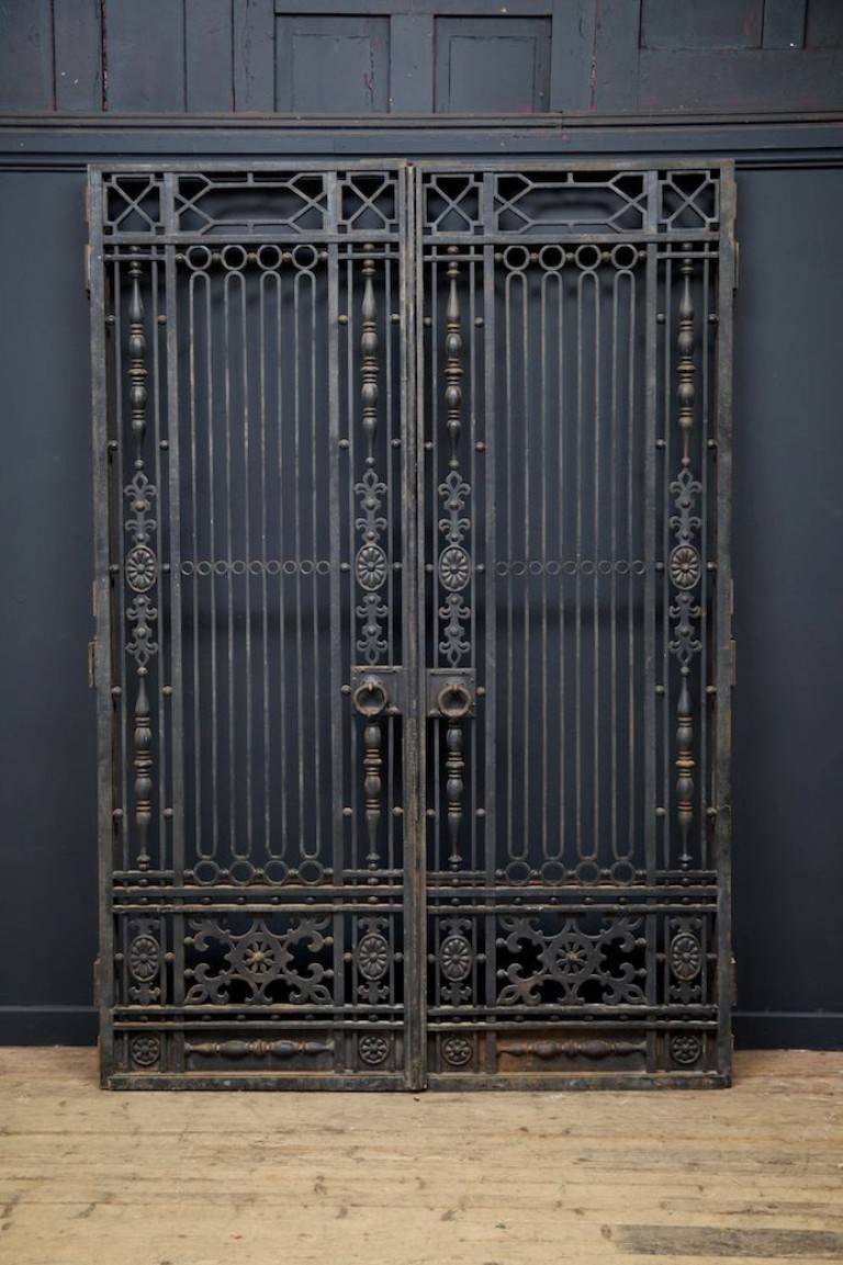 A pair of wrought iron internal doors with overdoor. 
Secondary opening frames to the rear of all that would have been glazed with clear glass or mirror. 
French, early 20th century. 
Height: 286 cm, width: 148 cm, depth: 6 cm.