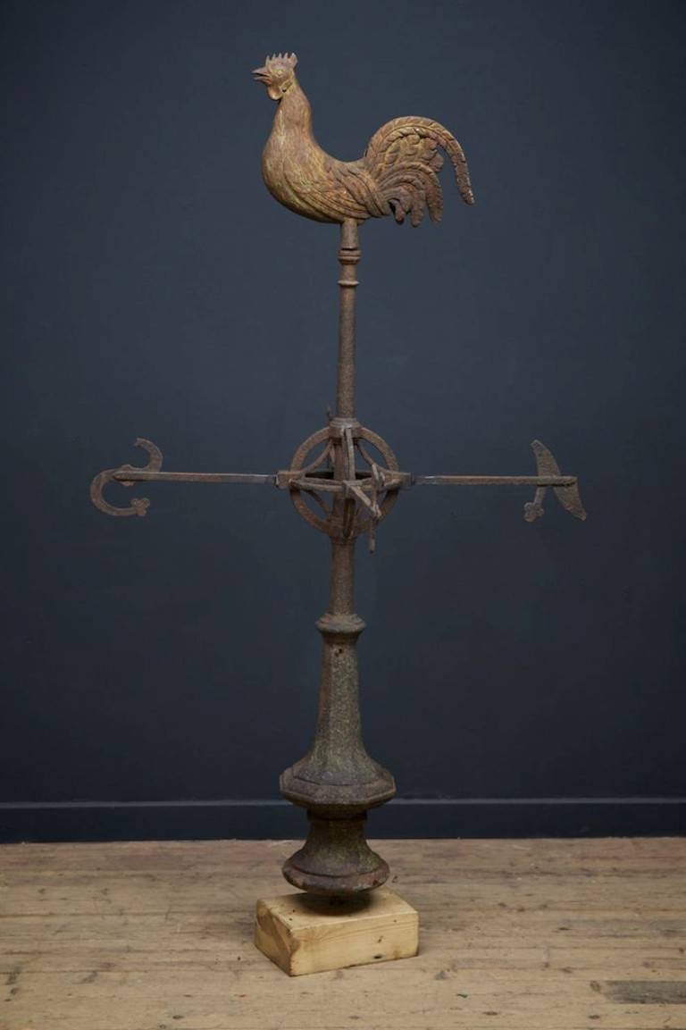 A cast iron weather vane.
Almost life-size crowing cockerel above N, S, E, W in the Arts and Crafts manner.
English, circa 1870.
Height: 174 cm width: 103 cm depth: 103 cm.