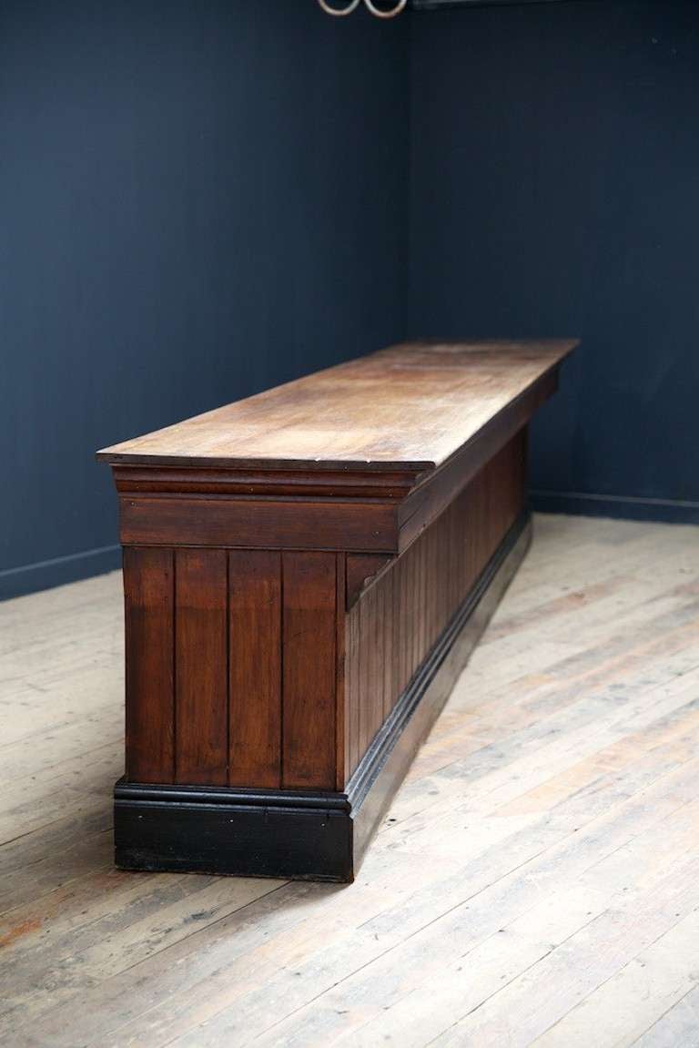 A late Victorian shop counter. 
Beautiful aged one piece mahogany plank to top, pine construction, nine drawers to behind. 
Great original condition, simple elegant design. 
English, late 19th century.