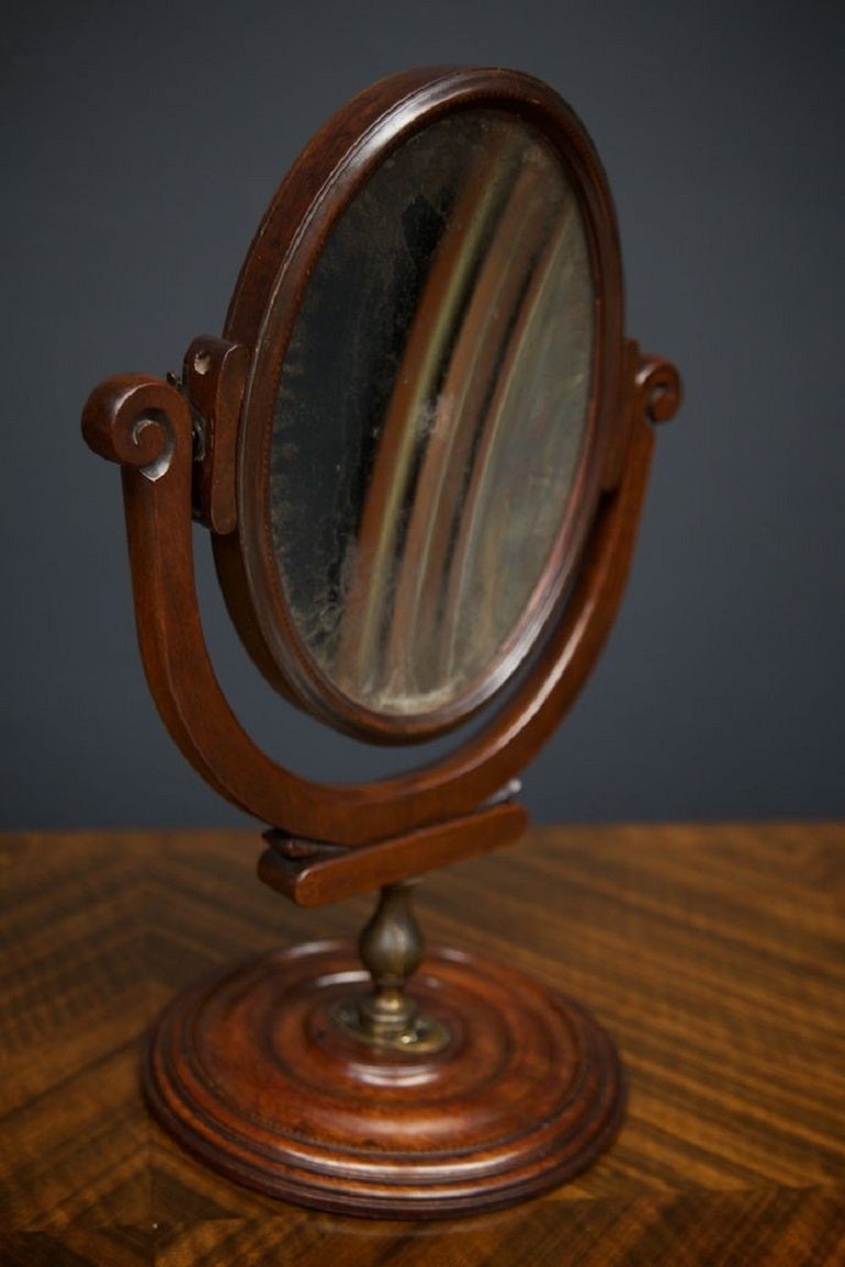 A double sided English Regencey mahogany vanity mirror. 

Of the finest quality we’ve ever seen, this George III vanity mirror swivels on a bronze patinated socle, the double sided mirror in its distressed Mercury plate has a beautiful soft