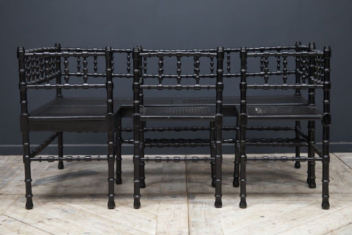 A ebonised corner bench with two corner seats en suite. 

Turned legs, backrest and stretchers, rattan seats. 

Elegant, simple and will work in most interiors. 

European circa 1890. 

Bench H:73 W:147 D:27 CM. 

Chair H:73 W:41 D:41 CM.