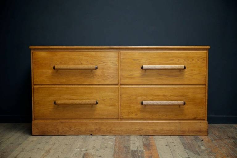 Oak departmentretail department store linen chest of drawers. 
Beautiful quality, reeded oak oval drawer pulls with unpolished bronze fittings. 
english 1920s. 
Height: 91 cm Width: 181 cm Depth: 59 cm