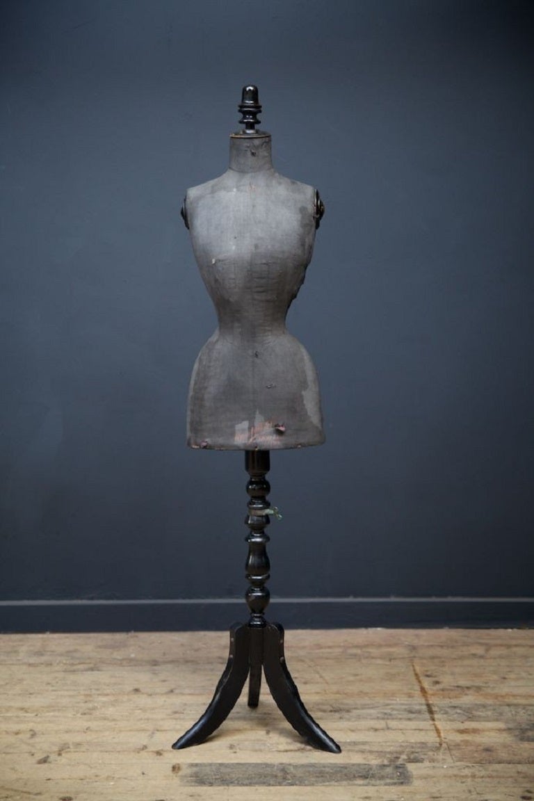 Upholstered female mannequin on adjustable ebonised stand. 

Wasp waist, retailer mark to the distressed linen. 

English circa 1880. 

H:154 W:33 W 22 CM