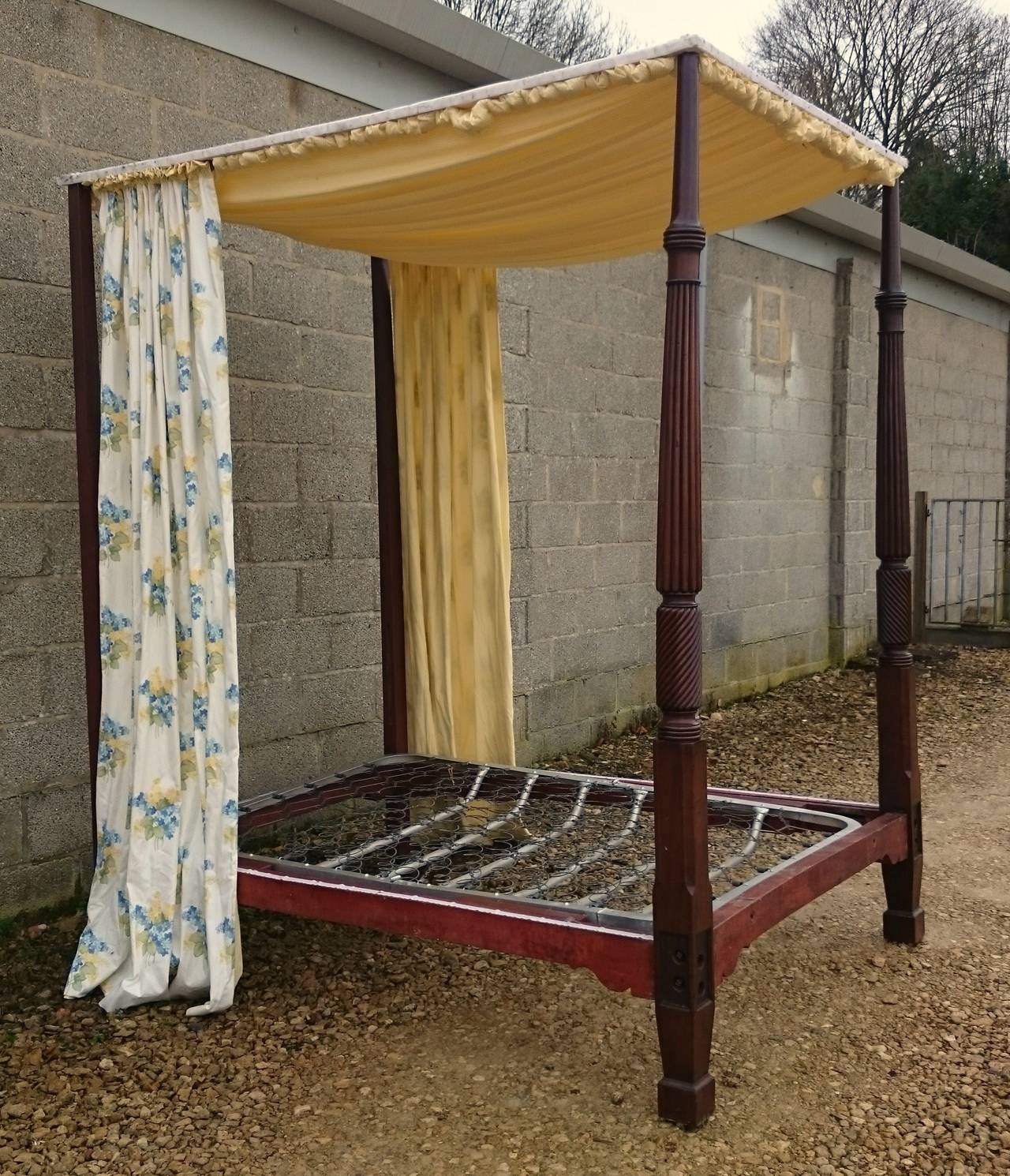 Antique four poster bed with turned front columns made of really splendid Cuban mahogany. The front posts are also reeded and have rope twist which was popular following the British naval victories at the start of the 19th century. Can be made