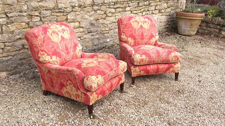 Pair of Howard and Son Grafton model armchairs standing on square taper legs. These chairs were sold by us and fully restored around 15 years ago and are now good and soft. They are upholstered in a copy of the original fabric and are finished with