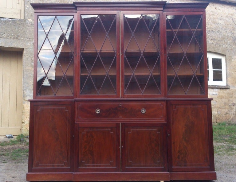 Good imposing and very original secretaire bookcase made of mahogany with flame mahogany bookmatched verneers on the doors and drawers, the whole piece is exceptionally well made with precision hand cut dove tails and tenon jointed panelling to the
