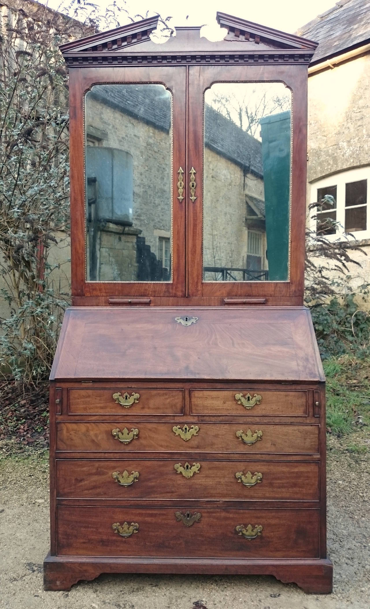 This 18th century antique bureau bookcase is made of an exceptionally fine cut of Cuban mahogany. The timber is really dense and has an especially interesting grain pattern. 
The construction is second to none, the interior is fitted out with many