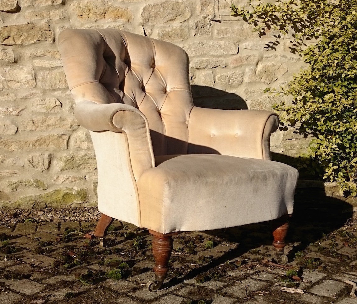 Good early button back antique armchair made by Howard and Sons of Berners Street, London. 
This chair is much larger than it looks in the photographs and the proportions work very well. The back is high enough to rest the head and the arms are far