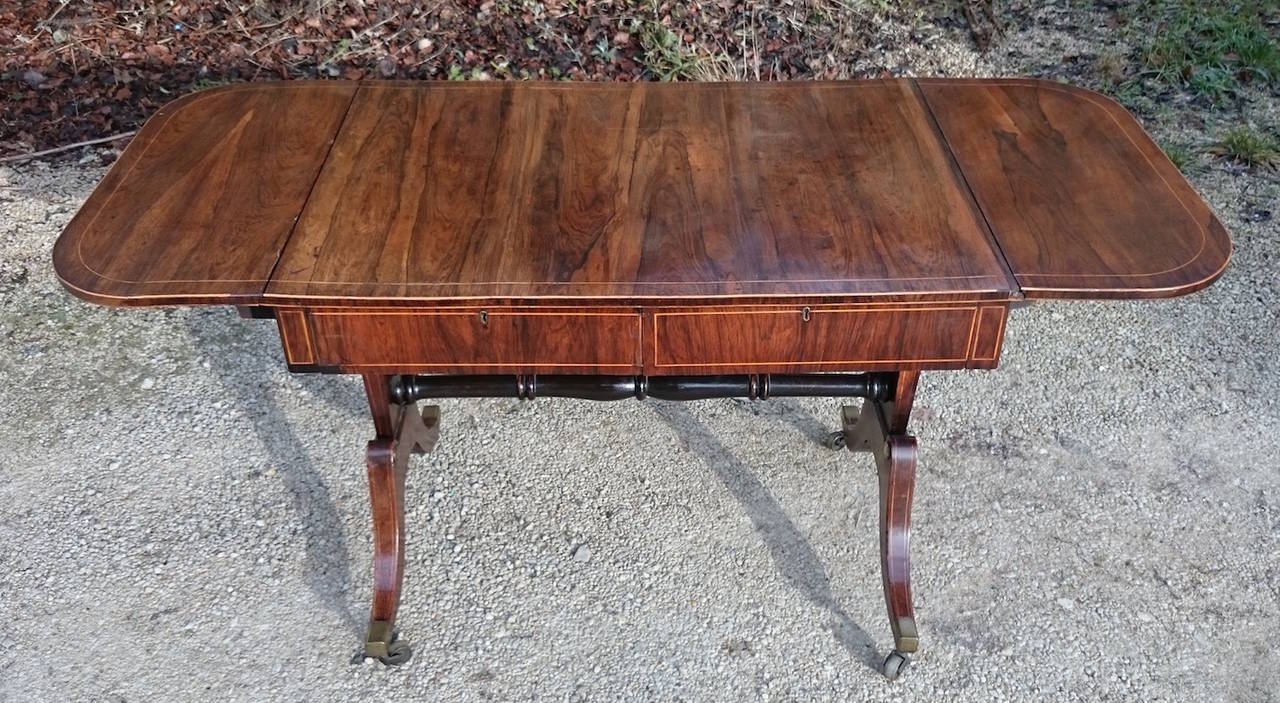 Antique sofa table made of rosewood, one of the finest timbers available. This sofa table has it all, mahogany drawer linings, stringing, end supports and is finished to the reverse. 

English circa 1820 

253⁄4