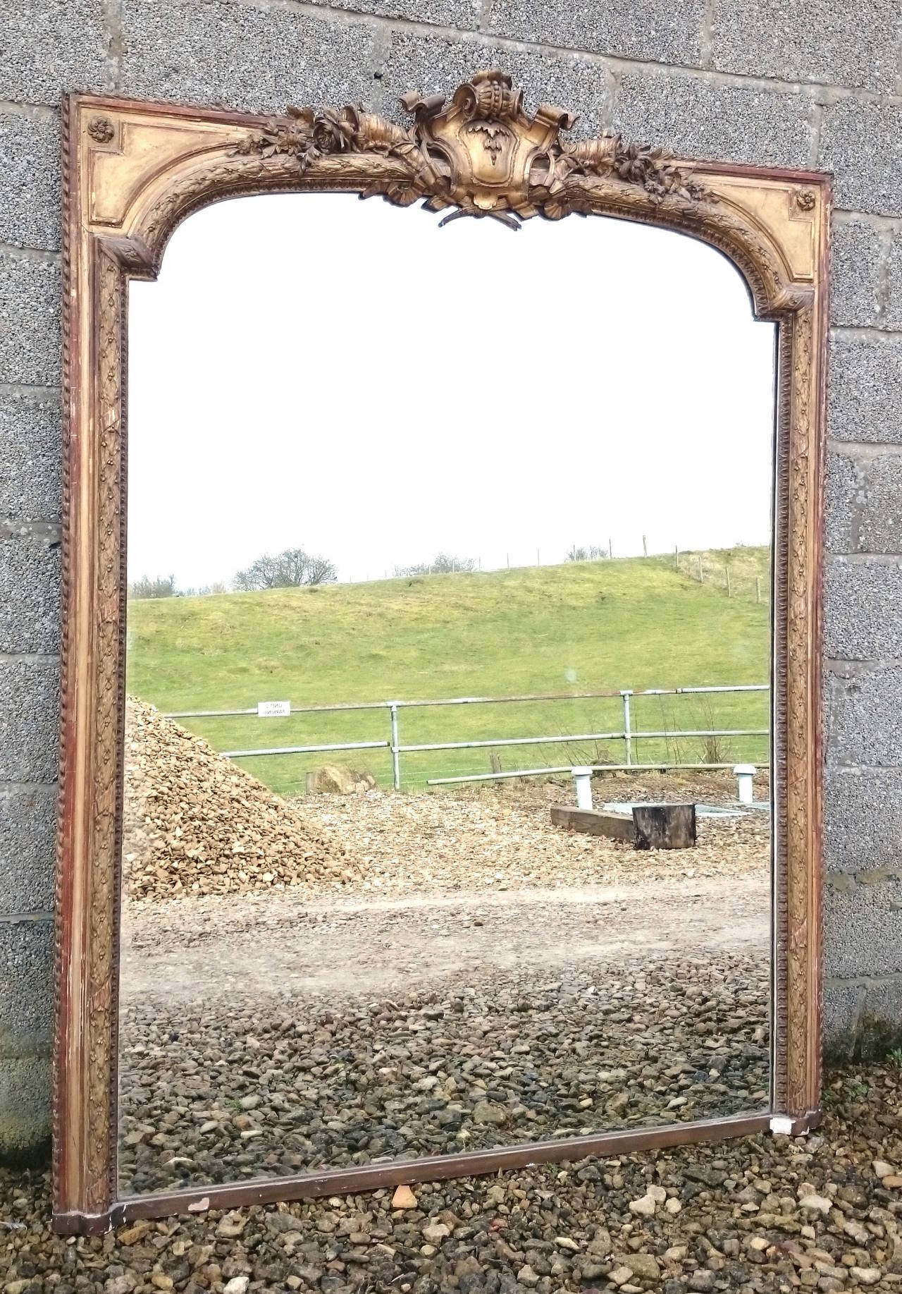 Large antique mirror with carved and gilt frame. This mirror has especially fine detail to the decoration and good clear new mirror plate. 

English circa 1850 
59