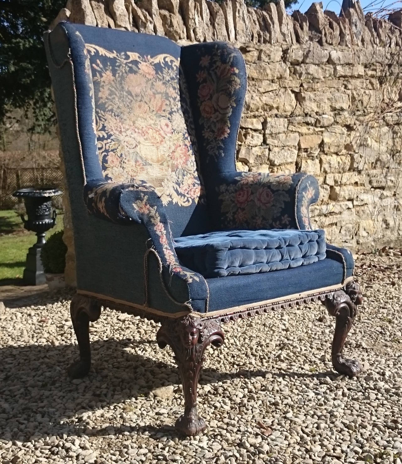 This is a really good scale antique wing chair with a generous shape to the overall frame design and exaggerated cabriole legs all round. It is unusual to have such a high level of detail on a chair of this period and especially to be so well