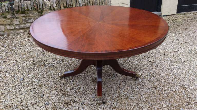 Regency style breakfast table made of very fine book matched segments of mahogany on the top with solid mahogany base, around 53
