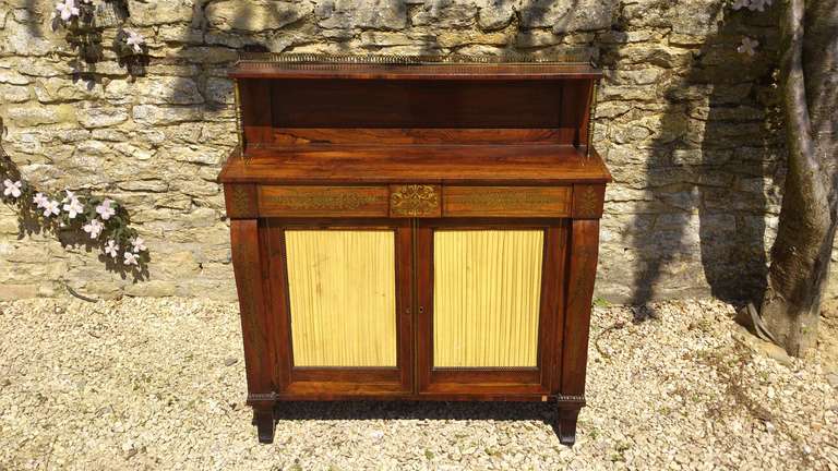 Very fine little Regency mahogany brass inlaid chiffonier made of lovely faded rosewood with useful large cupboard below, the whole piece being unusually narrow front to back, perfect for a smaller space. The brass inlay is especially exquisite,