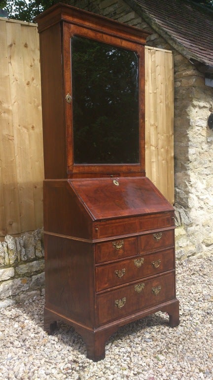 Unusually small scale George I period walnut bureau bookcase, this is a fine example of its type with really interesting walnut veneers with mitred corners, moulded edging, cross banding, bevelled glass, fitted desk interior with well and working