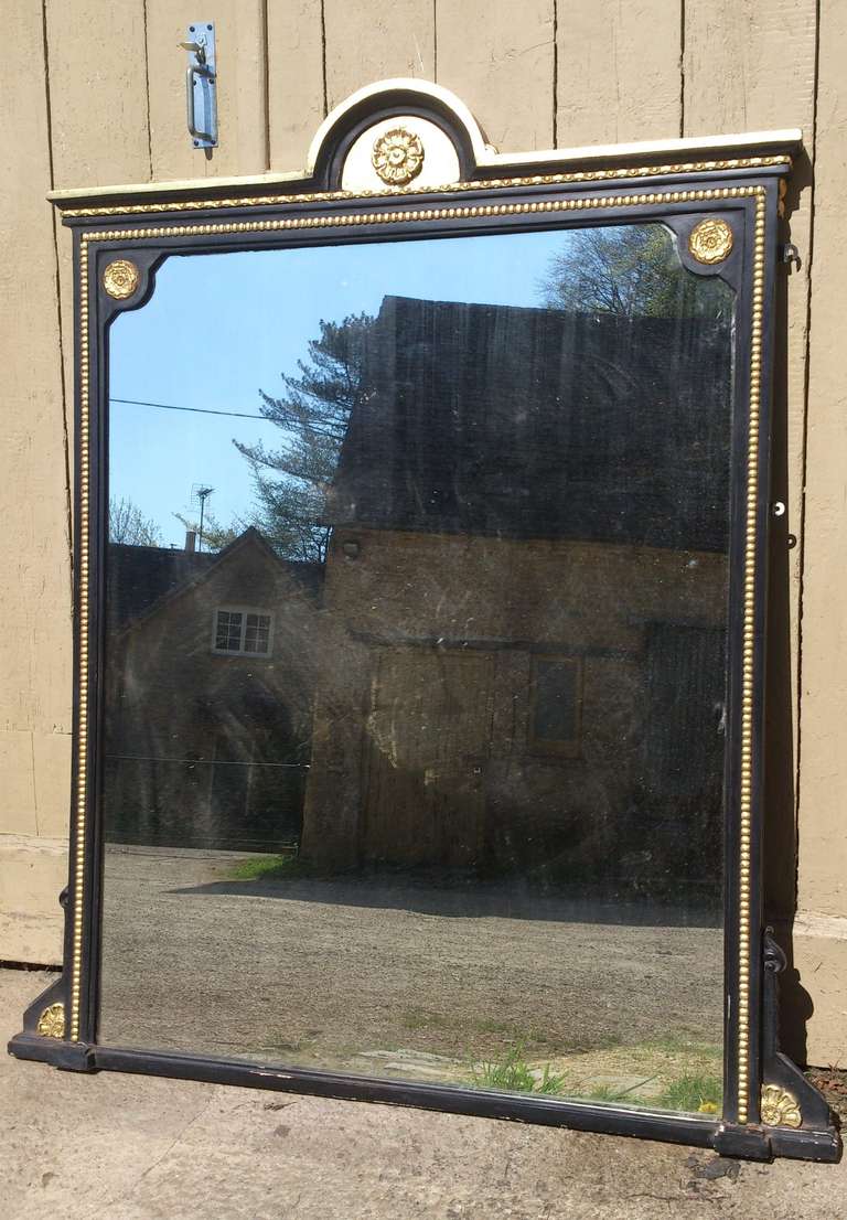 Very fine quality 19th century ebonised and gilt overmantal mirror. This mirror is a tremendous scale with good precise detailed decoration. It is properly made with panelled back and original glass. The silvering has minor imperfections across as