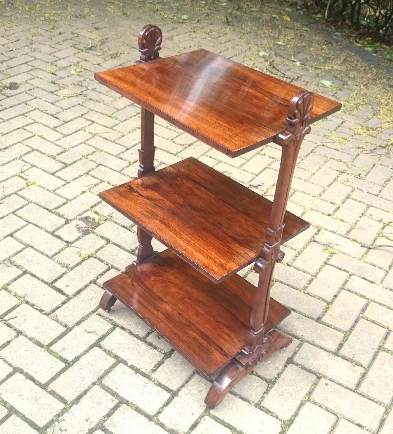 Lovely little antique whatnot, this very useful whatnot is made of wonderful rosewood and is a great small scale, perfect to use next to sofa as a wine table, with shelves for magasines, books, gin and tonic, remote controls etc. 

English circa