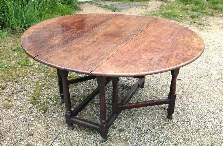 Antique gateleg dining table made of good timber with nice grain pattern, the base has thin stretchers and supports making the structure appear delicate and light, when in fact this table is surprisingly heavy.

English circa 1750

53