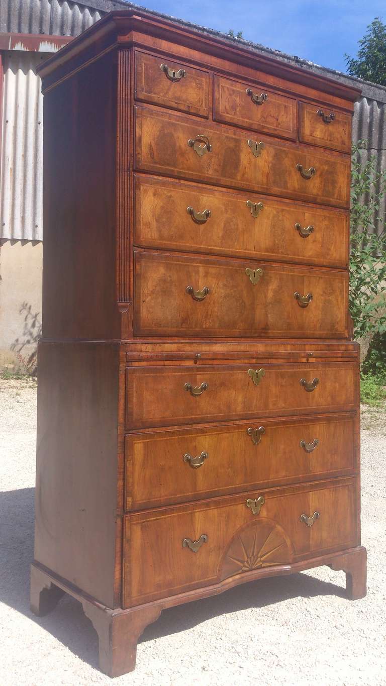 This extremely fine quality antique chest on chest (or 'tallboy'/'highboy') was made before mahogany had began to be imported into the United Kingdom. It is made of walnut and has feather banding round the drawers and the timber has been cut to make