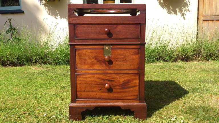 This is a very interesting pot cupboard, commode or washstand with a lift up lid! This is a very unusual configuration for the time, although the lift up lid works in the way in which we are now all familiar. 
This piece looks very nice with