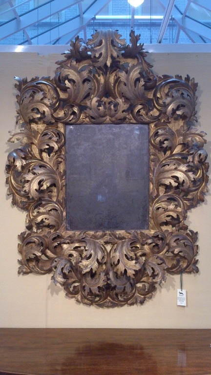 Very rare 17th century carved wood and gilded Rococo mirror with lovely old glass, the interesting thing about this mirror is the scale of the carving and the generosity of the form, quite theatrical and simply wonderful, Italian (probably Bologna)