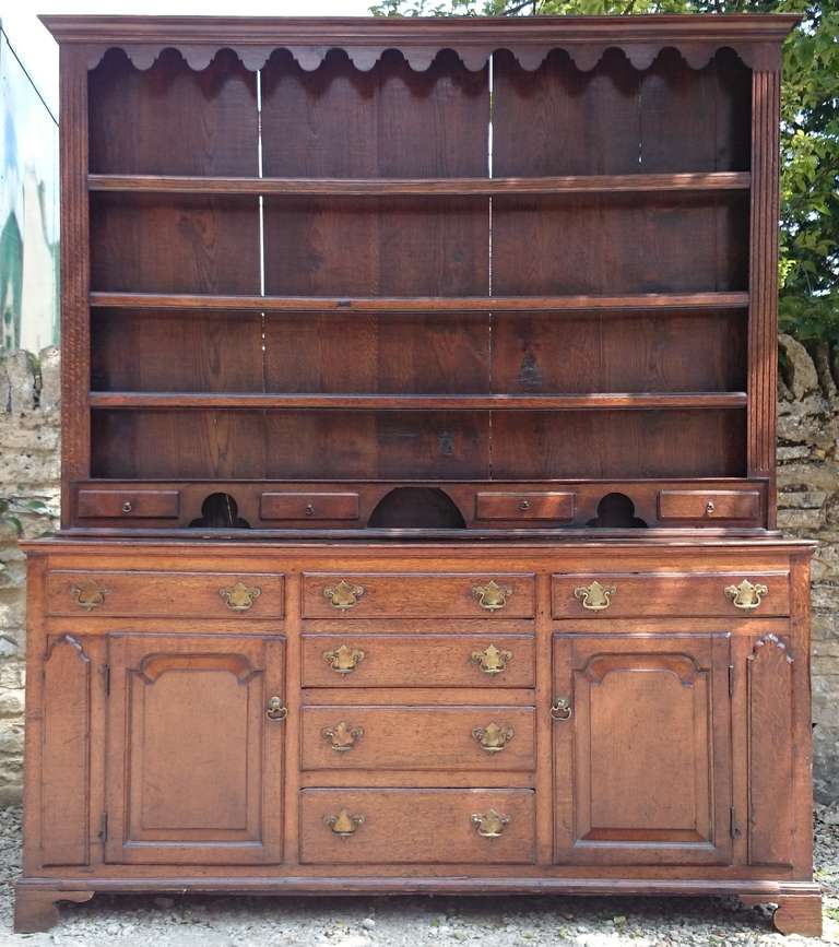 Early antique 270 year old oak cupboard with lots of lovely features. This one has lots of storage space, as well as the more usual drawers above. The carved detail adds an extra dimension as does the old metalwork on for hanging things on. The oak