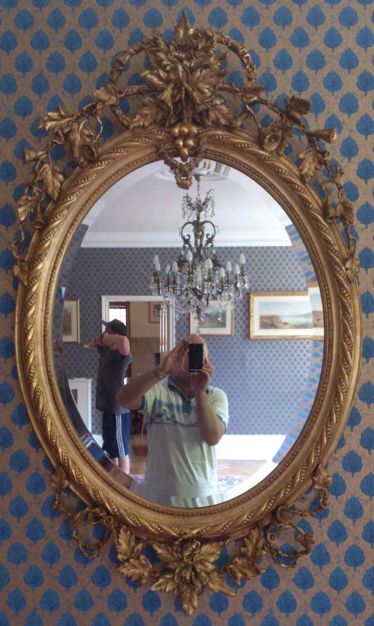 19th century oval antique mirror with especially fine detail to the decoration 

30