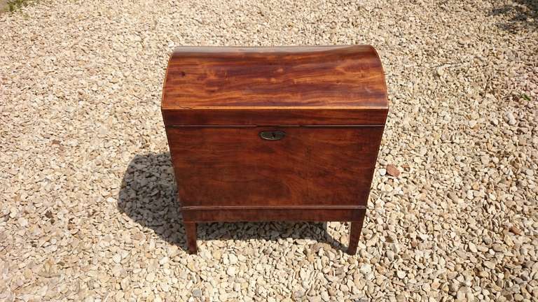 Antique wine cooler made of mahogany with stringing. This wine cooler is rectangular with a dome top. As usual it has a lock to keep the servants and children out. It stands on square taper legs typical of the period and has the original casters.