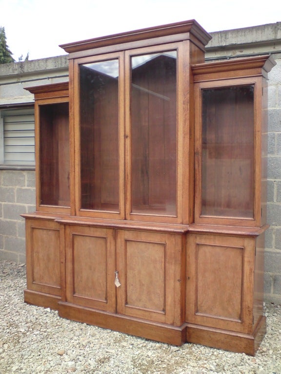 Large oak antique breakfront bookcase unusually with the centre section taller than the sides, this bookcase is wonderfully restrained and is made of a very interesting and well figured cut of oak that has faded to a lovely pale colour, English