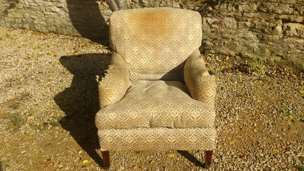 A fine and supremely comfortable armchair made by Howard and Sons of London. This chair is upholstered using the finest grade horsehair and pure down feathers. There is no foam or other post-war material used in the construction. Howard and Sons had