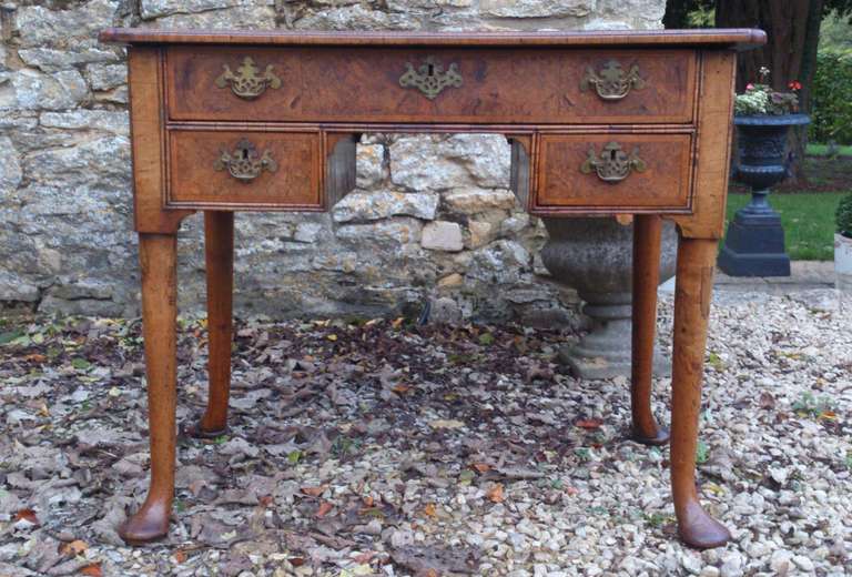 This is a really fine example of a lowboy from the age of walnut. Interestingly it is partly finished at the back and the molding runs all the way around the top as if it was intended to be free standing. Another great feature is the double cock