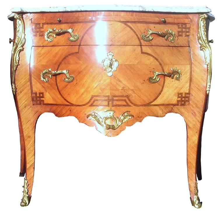 Unusual and important commode chest of drawers with brushing slide, marble top and brackets on which to hang linens. This piece would have been used as a washstand in a bedroom, but not just any bedroom, it would have been made for the bedroom of