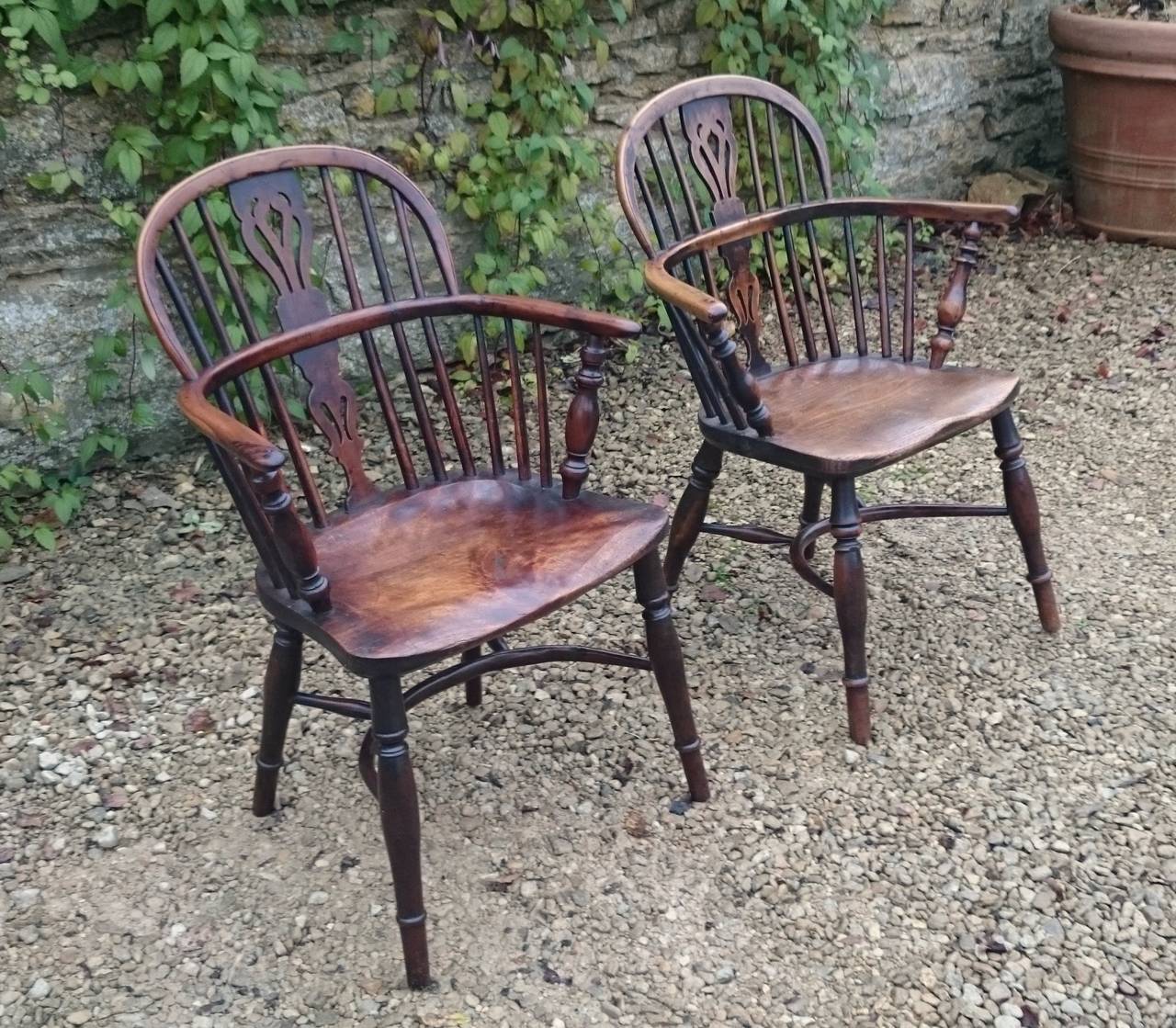 Nice near pair of Windsor chairs. These are a really generous shape with good play to the legs and fantastic colour and patination. It is interesting to see the difference in colour between the different timbers. The backs and arms are made of yew