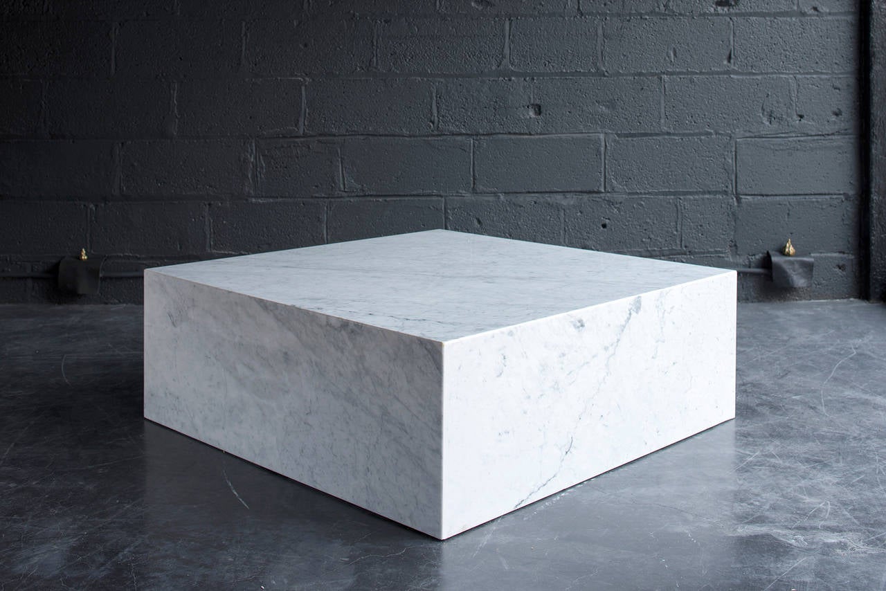 Pure, Minimalist form. Carrara marble on hidden wood frame. Exceptional condition; had been stored in an unopened crate since the 1960s. Versatile and multifunctional. Excellent as cocktail table or pedestal.